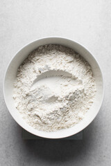 All purpose flour in a white bowl, baking flour in a large bowl