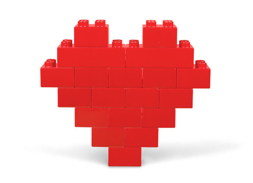 Red heart shape made of bricks on white background