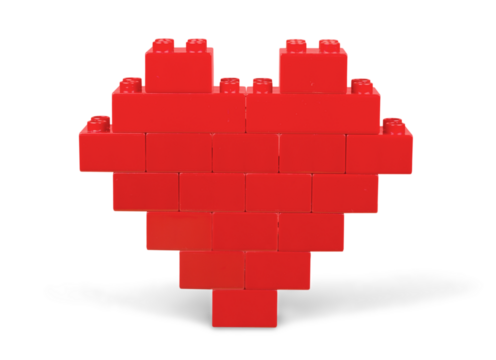Red heart shape made of bricks on white background