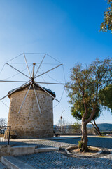 Fototapeta na wymiar Alacati windmills in Alacati Town near Izmir. Alacati is populer historical tourist destination in Turkey and the windmills are popular landmark.