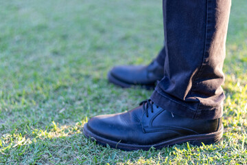 black shoes on green grass