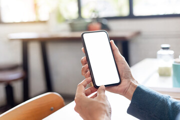 cell phone blank white screen mockup.hand holding texting using mobile on desk at office.background empty space for advertise.work people contact marketing business,technology