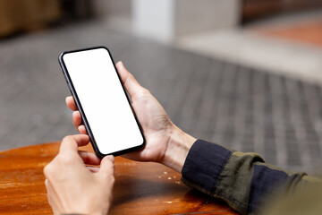 cell phone blank white screen mockup.hand holding texting using mobile on desk at office.background empty space for advertise.work people contact marketing business,technology