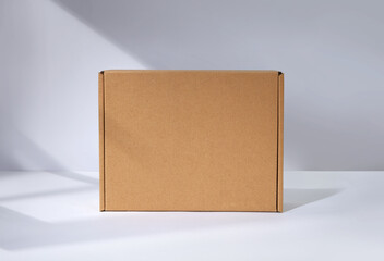 Empty cardboard Box with window shadow - obrazy, fototapety, plakaty