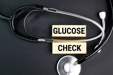 stethoscope with the words GLUCOSE CHECK. health checkup concept. medical and patient concepts