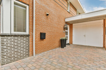 a brick house with an attached garage door and white shutters on the side of the house there is a...