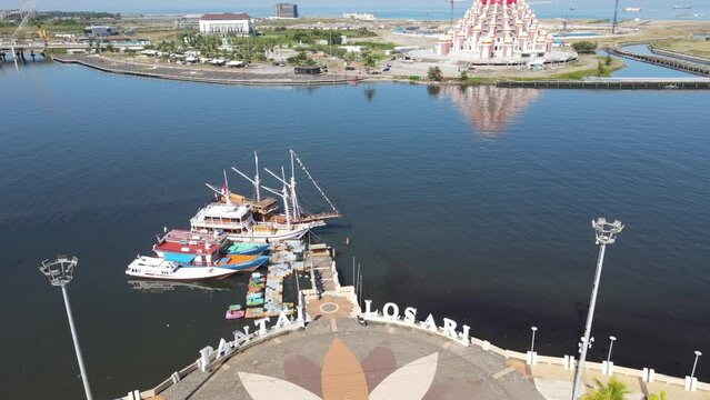 Aerial view of Masjid 99 Kubah (99 Domes Mosque) and its surrounding, a beautiful Mosque with unique architecture, located in famous destination, Losari Beach, Makassar, South Sulawesi, Indonesia. 