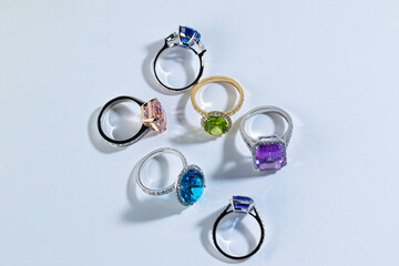 Six rings with bright gemstones tourmaline, topaz, amethyst, chrysolite, sapphire, aquamarine on...