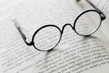 Reading concept.Education and schooling concept.Reading glasses on the pages of a book .Symbol of study, knowledge and reading.