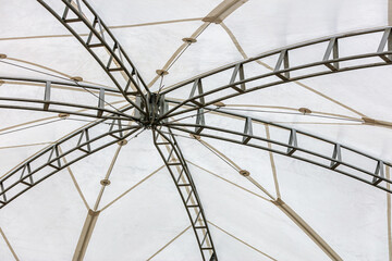 large white canvas tensile roof. architecture background. indoor view from below upwards.