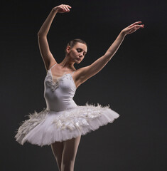 Beautiful ballerina dancing gracefully in the dark