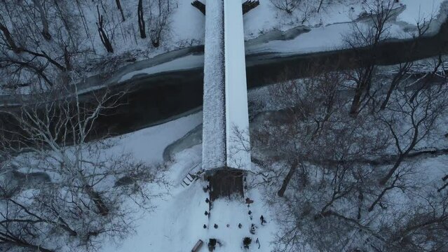 Aerial shot of covered bridge after a snow fall.
