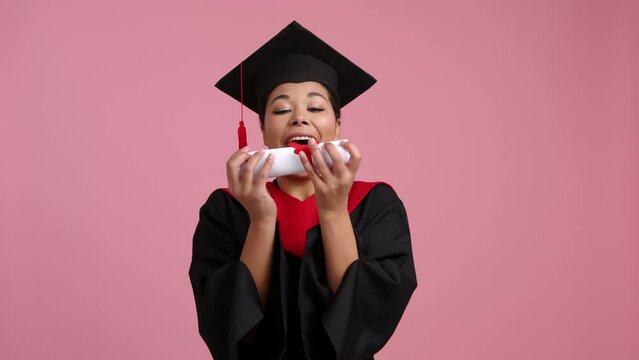 Portrait of a woman catching her bachelor degree document. Close-up of a beautiful, successful woman in black gown and hat smiling and looking cheerful. High quality 4k footage