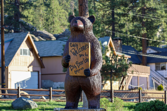 Louie the wooden bear statue holding a welcome to Big Bear Lake sign at Boulder Bay Park in Big Bear, California.