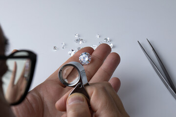 Process of evaluating diamond at diamond dealers workplace. High quality photo