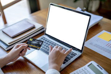 Woman shopping on laptop holding credit card for Internet online e-commerce shopping spending money Online shopping Mobile phone laptop technology concept