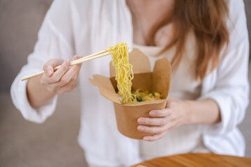 Asian woman with takeaway food and drinks at home. consumption eating home delivery food. enjoying delicious takeaway delivery tasty meal