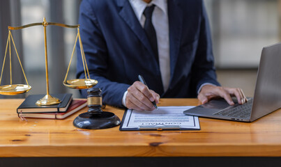 Close up of photo lawyer male notary working in a courtroom on wooden table office, Legal law, advice deal justice and law concept.