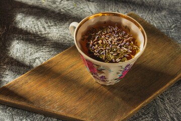 Still life- tea time. Mug of hot drink on a dark background