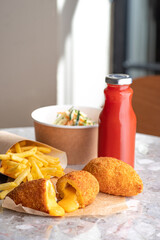Breaded Chicken Kiev breast stuffed with cheese.