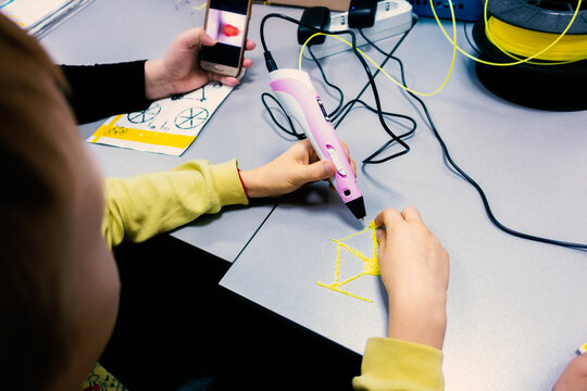 Children's Hands Create Figures Using A 3D Pen