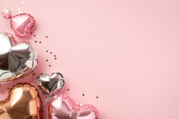 Saint Valentine's Day decor concept. Top view photo of heart shaped pink silver golden balloons and...