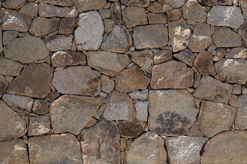 Stone wall as a background or texture. Texture of a stone wall. Old castle stone wall texture background.