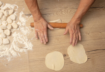 Rolling out the dough with your hands.