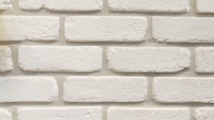 white stone beige wall of facade brick horizontal grunge background