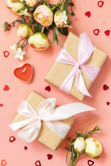Valentine's Day, Women's Day, birthday, mothers day greeting card background with handmade present box and spring flower on pink background. View from above.
