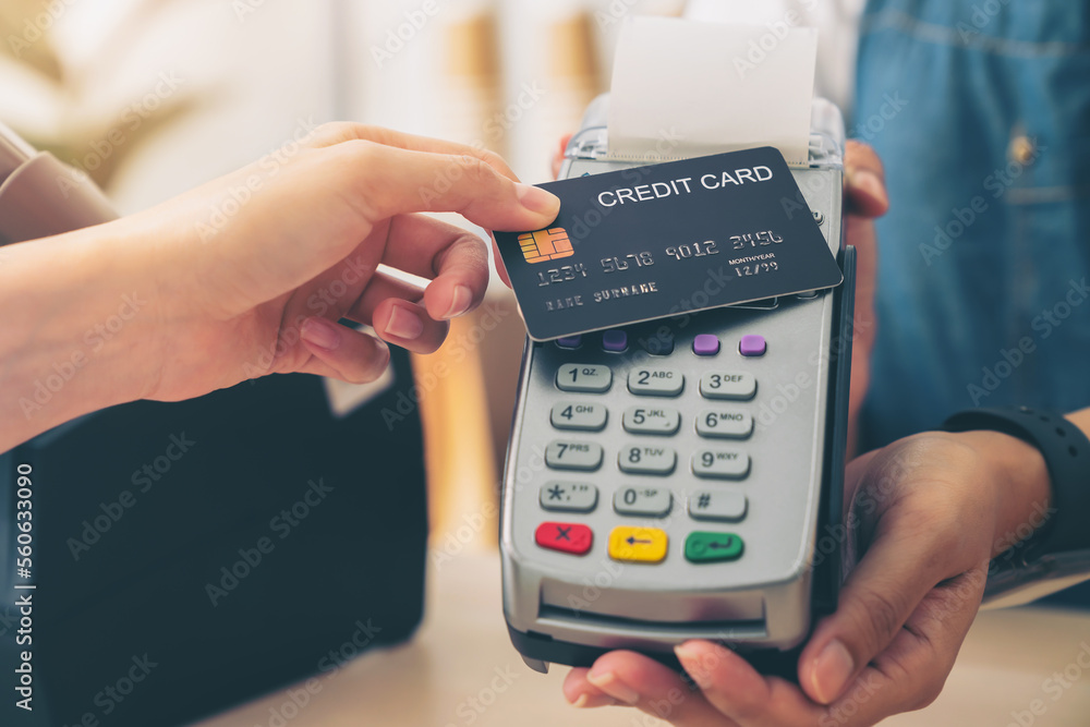Poster customer using credit card for payment by nfc technology on card reader machine to owner at restaura