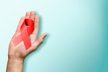 Healthcare concept, hands with red ribbon