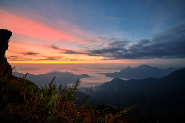 Dramatic sky with fog  in early morning over the mountain at Phu Chee Fah in Thailand