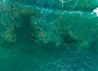 Aerial photography of group of surfers at beautiful waves of Atlantic Ocean, Portugal coastline.