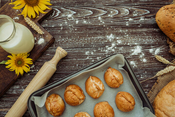 freshly baked pies, buns on baking sheet and crusty bread, useful farm milk, rolling pin, sunflower...