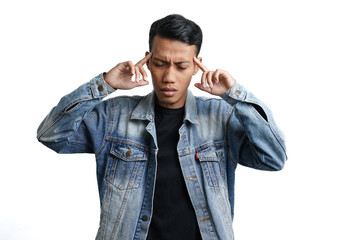 Asian man wearing blue jean jacket has headache or dizzy head. Isolated by white background