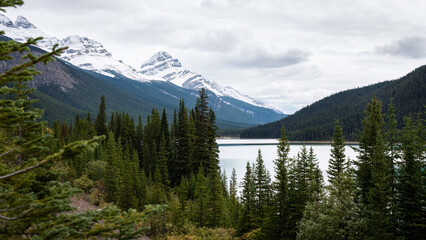 Snow-capped mountains and lake along Icefields parkway, Alberta, Canada.