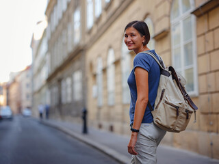 summer female solo trip to Europe, happy young woman walking on european street of Vienna, Austria