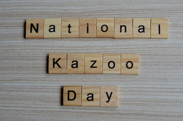 National Kazoo day text on wooden square, holiday concept quotes