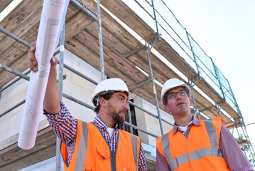 teamwork on the construction site - site manager and architect on site during the construction of a...