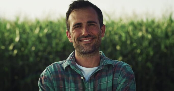  Portrait of a Handsome Middleaged Man Looking at the Camera with a Greenery Background. Farm Worker Happy with his Role in an Environment-friendly Small Business. Ecological Project Concept