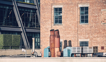 Urban scene with rusty exhaust pipes, color toning applied, New York City, USA.