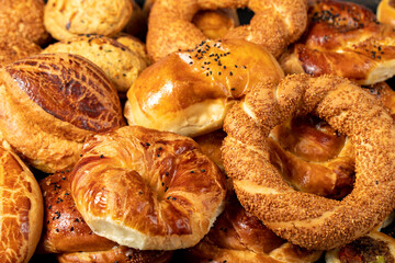 Bagel and pogaca varieties. They eat pastries in piles. Bakery products. Traditional turkish cuisine breakfast culture. Local name simit, pogaca, borek, acma. close up - obrazy, fototapety, plakaty