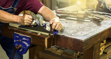 Close up carpenter working with tool in carpentry wood shop, Carpenter Concept