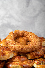 Bagel and pogaca varieties. They eat pastries in piles. Bakery products. Traditional turkish cuisine breakfast culture. Local name simit, pogaca, borek, acma. close up