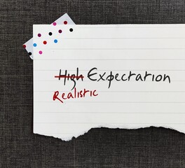 Stick note with handwritten HIGH EXPECTATION crossed HIGH off, replaced with REALISTIC, to be able...