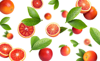 Red oranges with green leaves flying on white background