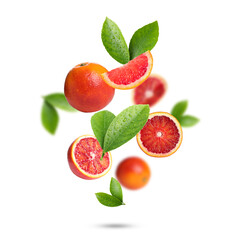 Red oranges with green leaves falling on white background