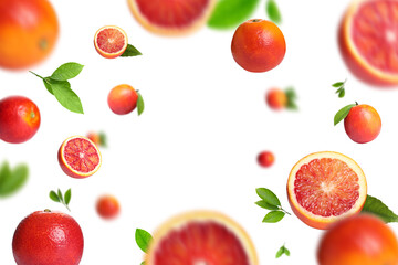 Red oranges with green leaves flying on white background