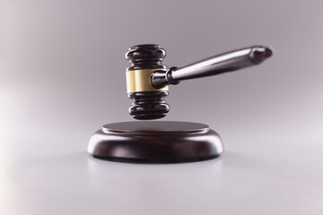 Brown wooden judge gavel in air closeup